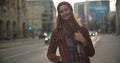 Portrait of beautiful youn woman standing in a city street.