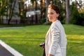 Portrait of beautiful young adult elegant stylish caucasian woman walking by green garden park in warm evening golden Royalty Free Stock Photo