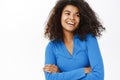 Portrait of beautiful young african american woman with shiny, curly healthy hair, posing happy, smiling, standing on Royalty Free Stock Photo