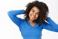 Portrait of beautiful young african american woman with shiny, curly healthy hair, posing happy, smiling, standing on Royalty Free Stock Photo