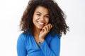 Portrait of beautiful young african american woman with shiny, curly healthy hair, posing happy, smiling, standing on Royalty Free Stock Photo