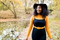 Portrait of a beautiful young african american woman smiling and staying outdoors Royalty Free Stock Photo