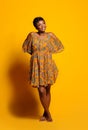 Portrait of a beautiful young African woman over yellow background. Studio picture Royalty Free Stock Photo