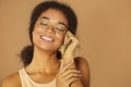 Young happy african american woman with closed eyes holding twig with leaves in her fist and smiling Royalty Free Stock Photo