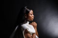 Portrait of a beautiful young African woman in white dress over black background Royalty Free Stock Photo