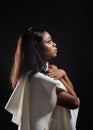 Portrait of a beautiful young African woman in white dress over black background Royalty Free Stock Photo