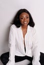 Portrait of a beautiful young African woman in white dress over grey background Royalty Free Stock Photo