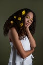 Portrait of a beautiful young African woman with yellow flowers in hair. Fashion beauty close up portrait Royalty Free Stock Photo