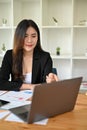 Portrait, Beautiful young Asian businesswoman or female accountant looking at laptop screen Royalty Free Stock Photo