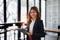 portrait of Beautiful young asian businesswoman presents business profits to colleagues at meeting, explaining business Royalty Free Stock Photo