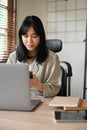 Portrait, Beautiful young Asian businesswoman using her mobile phone at her office desk Royalty Free Stock Photo