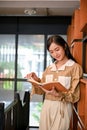 Portrait, Beautiful young Asian female in a bookstore or a library, reading a book Royalty Free Stock Photo