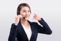 Portrait of beautiful young asian female customer service representative in headset looking at camera and smiling while isolated Royalty Free Stock Photo