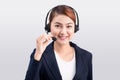 Portrait of beautiful young asian female customer service representative in headset looking at camera and smiling while isolated Royalty Free Stock Photo