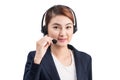 Portrait of beautiful young asian female customer service representative in headset looking at camera and smiling while isolated Royalty Free Stock Photo