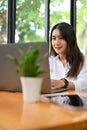 Portrait, Beautiful young Asian female office worker focused working on her laptop computer Royalty Free Stock Photo