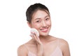 Portrait of beautiful young asian model applying some powder using powder puff Royalty Free Stock Photo