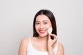 Portrait of beautiful young asian model applying some powder using powder puff Royalty Free Stock Photo