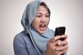 Muslim Woman Angry While Reading Text Message on Smart Phone Royalty Free Stock Photo