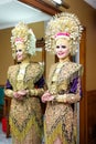 Portrait of beautiful young Asian muslim woman wearing traditional Minangkabau ethnic traditional dress standing by mirror Royalty Free Stock Photo