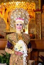 Portrait of beautiful young Asian muslim woman wearing traditional Minangkabau ethnic traditional dress holding flower bouquet