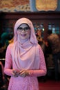 Portrait of beautiful young Asian muslim woman in wedding party with eyeglasses wearing pink dress and hijab Royalty Free Stock Photo