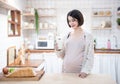 Portrait beautiful young asian pregnant woman drink milk glass standing in kitchen at home.Health care and love of pregnancy Royalty Free Stock Photo