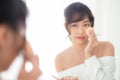 Portrait beautiful young asian woman applying powder puff at cheek makeup of cosmetic looking mirror Royalty Free Stock Photo