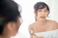 Portrait beautiful young asian woman applying powder puff at cheek makeup of cosmetic looking mirror Royalty Free Stock Photo