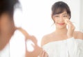 Portrait beautiful young asian woman applying powder puff at cheek makeup of cosmetic looking mirror Royalty Free Stock Photo
