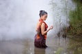 Portrait of beautiful young Asian woman bathing in the river Royalty Free Stock Photo