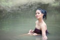 Portrait of beautiful young Asian woman bathing in the river Royalty Free Stock Photo