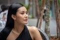 Portrait of  beautiful  young asian woman in a black dress looking away in city outdoor Royalty Free Stock Photo