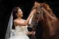 Portrait of a beautiful young asian woman bride and brown horse Royalty Free Stock Photo