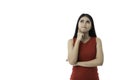 Portrait of beautiful young Asian woman in casual business red dress is looking up, pointing cheek and crossed arm while thinking Royalty Free Stock Photo