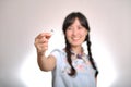 Portrait of beautiful young asian woman in denim dress holding engagement ring on white background Royalty Free Stock Photo