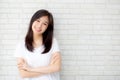 Portrait of beautiful young asian woman happiness standing on gray cement texture grunge wall brick background. Royalty Free Stock Photo