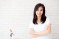 Portrait of beautiful young asian woman happiness standing on gray cement texture grunge wall brick background. Royalty Free Stock Photo