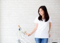 Portrait of beautiful young asian woman happiness standing on gray cement texture grunge wall brick background. Royalty Free Stock Photo