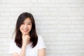 Portrait of beautiful young asian woman happiness standing on gray cement texture grunge wall brick background. Royalty Free Stock Photo