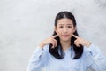 Portrait of beautiful young asian woman happiness standing touch cheek on gray cement texture grunge wall background Royalty Free Stock Photo