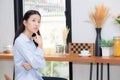 Portrait of beautiful young asian woman happiness and think sitting at cafe shop Royalty Free Stock Photo