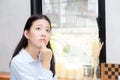 Portrait of beautiful young asian woman happiness and think sitting at cafe shop Royalty Free Stock Photo