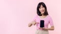 Portrait beautiful young asian woman happy smile showing smartphone screen with pointing finger hand gesture to mobile phone Royalty Free Stock Photo