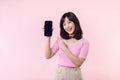 Portrait beautiful young asian woman happy smile showing smartphone screen with pointing finger hand gesture to mobile phone Royalty Free Stock Photo