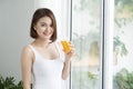 Portrait of a beautiful young asian woman having orange juice. Royalty Free Stock Photo