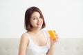 Portrait of a beautiful young asian woman having orange juice. Royalty Free Stock Photo
