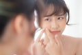 Portrait beautiful young asian woman looking the mirror is a acne, zit treatment, girl problem beauty face Royalty Free Stock Photo