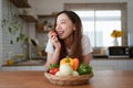 Portrait of beautiful young asian woman making salad at home. cooking food and Lifestyle moment Royalty Free Stock Photo