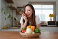 Portrait of beautiful young asian woman making salad at home. cooking food and Lifestyle moment Royalty Free Stock Photo